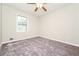 Neutral bedroom with a ceiling fan, window with natural light, and gray carpeting at 10 Canyon Cove Cv, Ellenwood, GA 30294