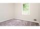 Neutral bedroom featuring a large window with natural light and gray carpeting at 10 Canyon Cove Cv, Ellenwood, GA 30294