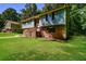 Charming two-story home with blue siding, brick foundation, and a well-manicured lawn at 10 Canyon Cove Cv, Ellenwood, GA 30294