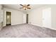 Spacious main bedroom featuring neutral paint, carpeted floor, ceiling fan, and ensuite bathroom at 10 Canyon Cove Cv, Ellenwood, GA 30294