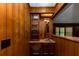 Bar area with wood paneling, built-in storage, lighting, and a sink at 2017 S Deshon Rd, Lithonia, GA 30058