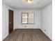 Bedroom with wood-look floors, a window, and a door at 2017 S Deshon Rd, Lithonia, GA 30058