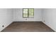 Minimalist bedroom with wood-look floors and ample natural light at 2017 S Deshon Rd, Lithonia, GA 30058