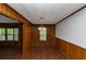 Well-lit dining room featuring wood paneling, laminate floors and a view to the exterior at 2017 S Deshon Rd, Lithonia, GA 30058