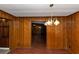 Spacious dining room features decorative lighting and wood paneled walls at 2017 S Deshon Rd, Lithonia, GA 30058
