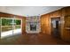 The living room has hard floors, wood paneling, a stone fireplace, and a sliding glass door at 2017 S Deshon Rd, Lithonia, GA 30058