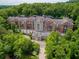 Aerial view of condo complex surrounded by lush trees and manicured landscaping at 3280 Stillhouse Se Ln # 410, Atlanta, GA 30339
