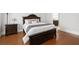 Beautiful main bedroom boasting a luxurious bed with wood floors at 3280 Stillhouse Se Ln # 410, Atlanta, GA 30339