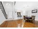 Open dining room featuring hardwood floors, modern lighting, and a view of the breakfast bar at 3280 Stillhouse Se Ln # 410, Atlanta, GA 30339