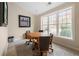 Cozy dining room features a large window offering natural light and comfortable seating for four at 3280 Stillhouse Se Ln # 410, Atlanta, GA 30339