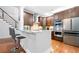 Modern kitchen with stainless steel appliances, large countertop, and hardwood floors at 3280 Stillhouse Se Ln # 410, Atlanta, GA 30339