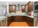 Spacious kitchen featuring modern appliances, tile backsplash, and hardwood floors at 3280 Stillhouse Se Ln # 410, Atlanta, GA 30339