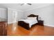 Bright main bedroom with hardwood floors, neutral colors, and attached bathroom at 3280 Stillhouse Se Ln # 410, Atlanta, GA 30339