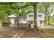 Back exterior view of the home featuring a large wooden deck at 4510 Virginia Nw Ave, Kennesaw, GA 30144