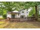 Exterior view shows a large wooden deck and lush trees at 4510 Virginia Nw Ave, Kennesaw, GA 30144