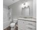 Bathroom featuring a white vanity with granite countertop, stylish mirror, and tub-shower combo at 4510 Virginia Nw Ave, Kennesaw, GA 30144