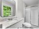 A cozy bathroom with granite countertops and a stand up shower with shiny sliding door at 4510 Virginia Nw Ave, Kennesaw, GA 30144