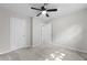 Neutral bedroom featuring plush carpeting, a ceiling fan, and a closet at 4510 Virginia Nw Ave, Kennesaw, GA 30144
