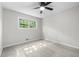 Bedroom featuring new carpet, a ceiling fan, and a bright, leafy view window at 4510 Virginia Nw Ave, Kennesaw, GA 30144