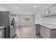 Bright dining area with stainless refrigerator and modern flooring at 4510 Virginia Nw Ave, Kennesaw, GA 30144