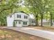 Beautiful two-story home featuring white siding, black accents, and a spacious driveway leading to a welcoming entrance at 4510 Virginia Nw Ave, Kennesaw, GA 30144