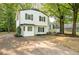 Inviting home with a manicured lawn, a concrete driveway, and a two-story white exterior with black shutters at 4510 Virginia Nw Ave, Kennesaw, GA 30144