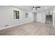 Bright living room with laminate floors, two windows, and access to the stairway at 4510 Virginia Nw Ave, Kennesaw, GA 30144