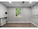 Utility room in basement features a window, vinyl flooring and storage at 4510 Virginia Nw Ave, Kennesaw, GA 30144