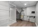 Basement utility area with laminate floor, water heater, and shelving at 4510 Virginia Nw Ave, Kennesaw, GA 30144