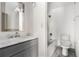 Bathroom featuring a marble vanity top and a shower-tub combo at 26 Ivy Ne Pkwy, Atlanta, GA 30342