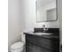 Elegant bathroom with black vanity, granite countertop, and stylish mirror at 26 Ivy Ne Pkwy, Atlanta, GA 30342