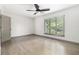 Bedroom featuring hardwood floors, a ceiling fan, and a large window for natural light at 26 Ivy Ne Pkwy, Atlanta, GA 30342