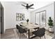 Bright dining area featuring modern decor, a stylish ceiling fan, and a large window for plenty of natural light at 26 Ivy Ne Pkwy, Atlanta, GA 30342