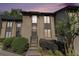 Two-story home with neutral-toned siding, complemented by manicured shrubs and trees and a warm and inviting entrance at 26 Ivy Ne Pkwy, Atlanta, GA 30342