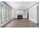 Open living room with a cozy fireplace, large window, and ample natural light creates an inviting atmosphere at 26 Ivy Ne Pkwy, Atlanta, GA 30342