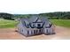 A gorgeous exterior view highlights the stone accents and covered porch of this stately home at 301 Eminence Peak, Rydal, GA 30171