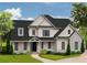 Stunning two-story home boasts a modern design with black trim windows and a well-manicured lawn at 301 Eminence Peak, Rydal, GA 30171