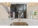 A stunning view of the living room, a fireplace, a staircase and decorative lighting at 301 Eminence Peak, Rydal, GA 30171