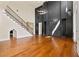 A living room features hardwood floors, a fireplace, a staircase, and a modern chandelier at 301 Eminence Peak, Rydal, GA 30171