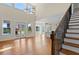 Bright, open-concept living area with hardwood floors, a modern light fixture, and easy access to the backyard at 301 Eminence Peak, Rydal, GA 30171