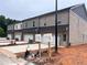New construction townhome featuring garages, light brick, and mailbox at 3230 Cyrus Creek Dr, Kennesaw, GA 30152