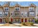 Three-story townhome featuring a red door, garage, and updated curb appeal at 380 Grant Se Cir # 110, Atlanta, GA 30315