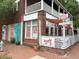 Howdy ATL restaurant, featuring a rustic brick building, outdoor patio, and vibrant signage at 380 Grant Se Cir # 110, Atlanta, GA 30315