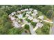 Aerial view of a friendly neighborhood with tree-lined streets, sidewalks, and picturesque landscaping at 4945 Racquet Ct, Duluth, GA 30096