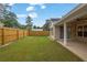 Backyard view of lush, green grass and a privacy fence at 4945 Racquet Ct, Duluth, GA 30096