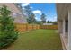 Green backyard is surrounded by a wooden fence at 4945 Racquet Ct, Duluth, GA 30096