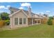 Home showcasing large backyard and covered patio at 4945 Racquet Ct, Duluth, GA 30096