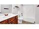 Bathroom featuring tile floors, wood cabinet, and a shower tub combination at 4945 Racquet Ct, Duluth, GA 30096