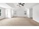 Large bedroom features tray ceilings, carpet, ceiling fan, and three entry doors at 4945 Racquet Ct, Duluth, GA 30096