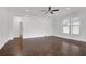 Spacious bedroom featuring a modern ceiling fan, wood-look floors, and a large window at 4945 Racquet Ct, Duluth, GA 30096